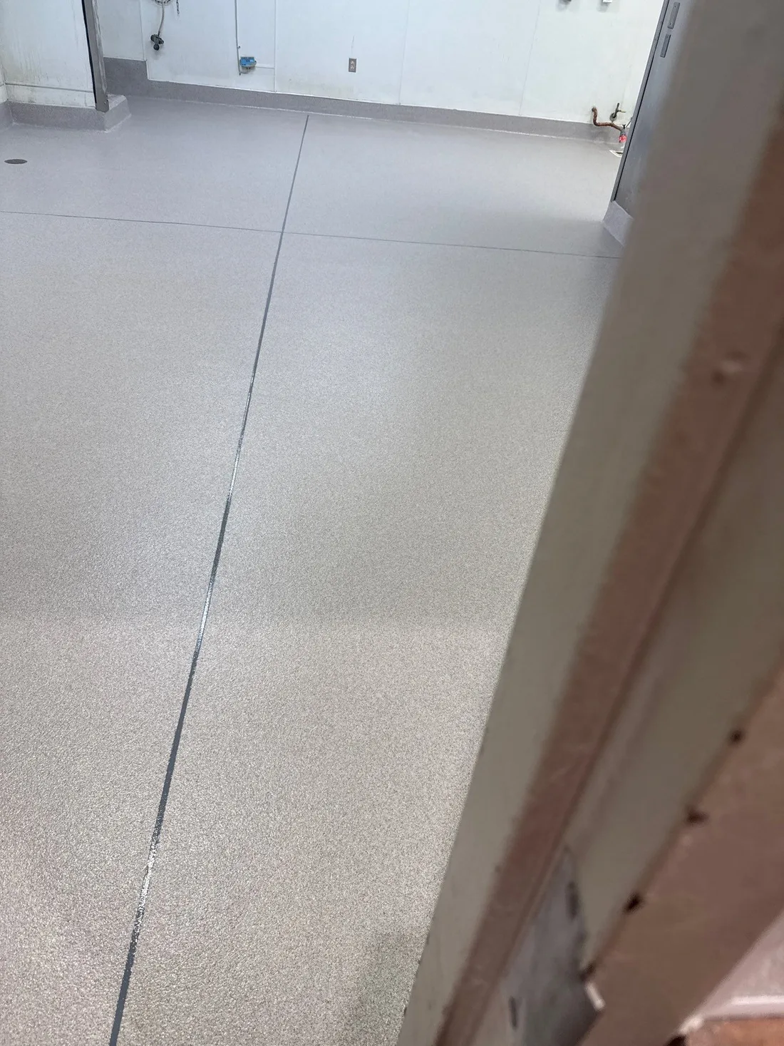 Finished seamless resinous floor in a food plant area built for daily washdowns